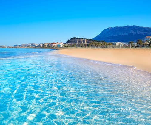 Photo of Denia beach in Alicante in blue Mediterranean with Montgo Alicante.