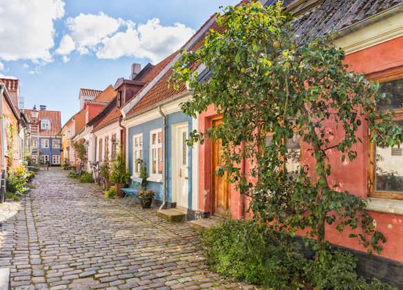 Photo of An idyllic cobbled street with colorful houses at the old town of Aalborg, Denmark.