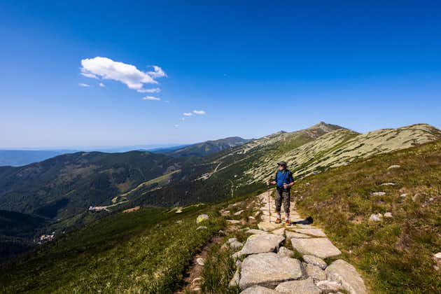 Photo of Senior man on a path around Chopok and Dumbier mountain with Stefanika shelter - in slovakian low Tatra mountains. Summer panorama with great weather and blue sky.