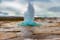 photo of the great geysir erupting in spring, Iceland.