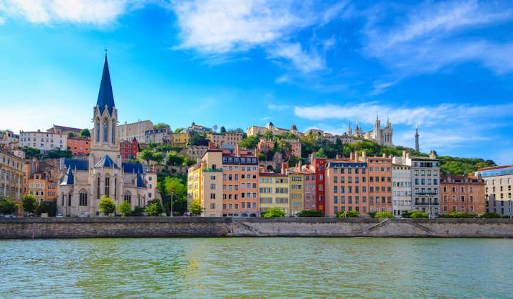Photo of Lyon cityscape from Saone river with colorful houses and river.