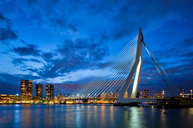 Photo of Erasmus Bridge (Erasmusbrug) and Rotterdam skyline cityscape illuminated at night. Rotterdam, Netherlands.
