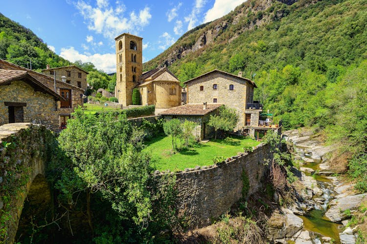 Photo of spectacular mountain village with old houses made of stone and Romanesque church with bell tower, Beget, Girona, Catalonia.