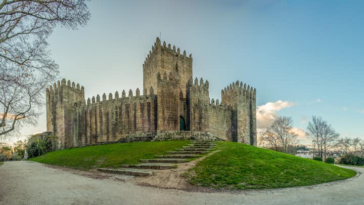 Photo of Guimaraes, Portugal - January 4, 2018 : End of a sunny day in the Winter next to the castle of GuimarÃ£es, Portugal.