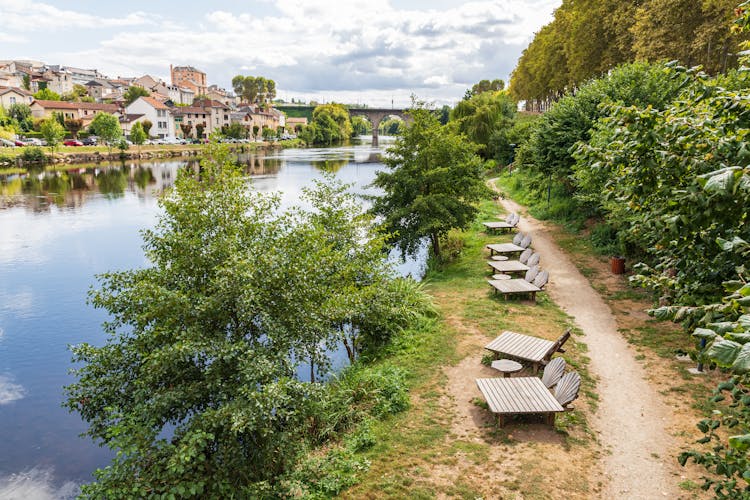 Photo of chaise lounges on a pathway along the Vienne River in Limoges.