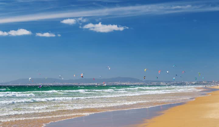 Photo of Kiteboarding on the Atlantic ocean beach at Fonte da Telha beach, Costa da Caparica, Portugal.
