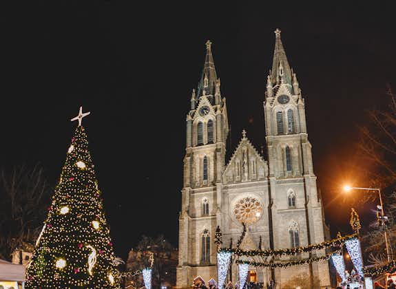 Photo of beautifully decorated Christmas tree in Namesti Miru Square against the backdrop of the majestic building of the St. Ludmila Church on Peace Square in Prague, Czech Republic.