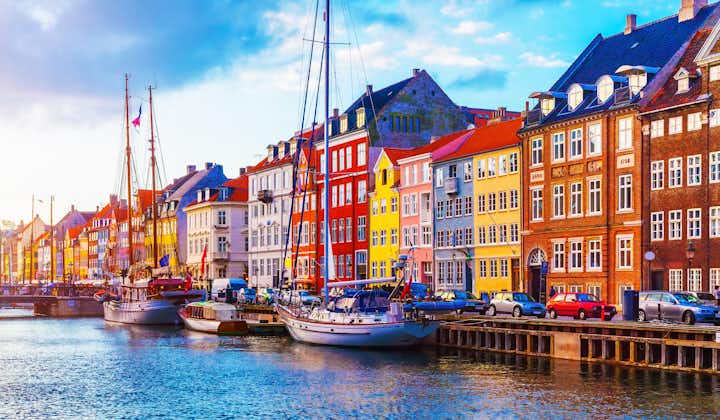 Scenic summer sunset view of Nyhavn pier with color buildings and ships in the Old Town of Copenhagen, Denmark