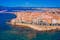 Photo of aerial view of Alghero on a beautiful day with harbor and open sea, Italy.