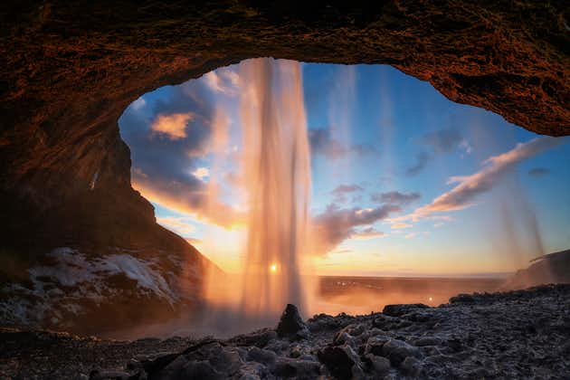 photo of warm photo of Seljalandsfoss view from inside in evening light before sunset, Iceland.