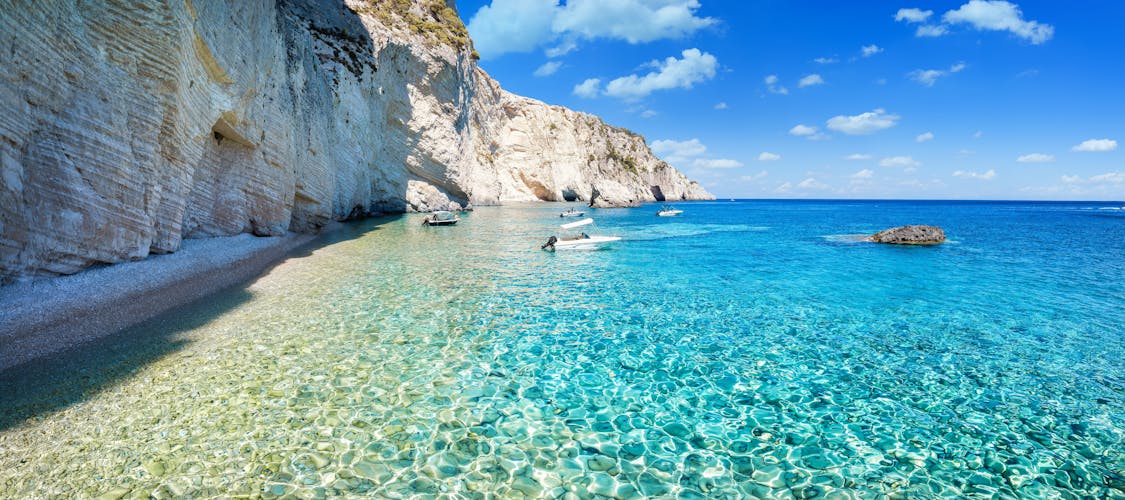 Photo of shining, turquoise sea next to the steep cliffs at the Ionian island of Zakynthos, Greece.